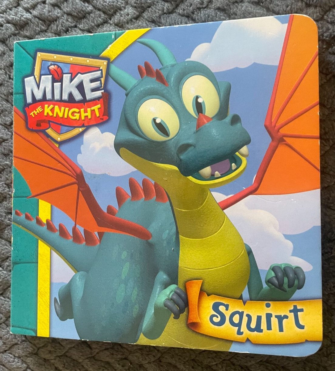 NEW. MIKE THE KNIGHT. SQUIRT. 14 BY 14CM. 2012 – BOARDED