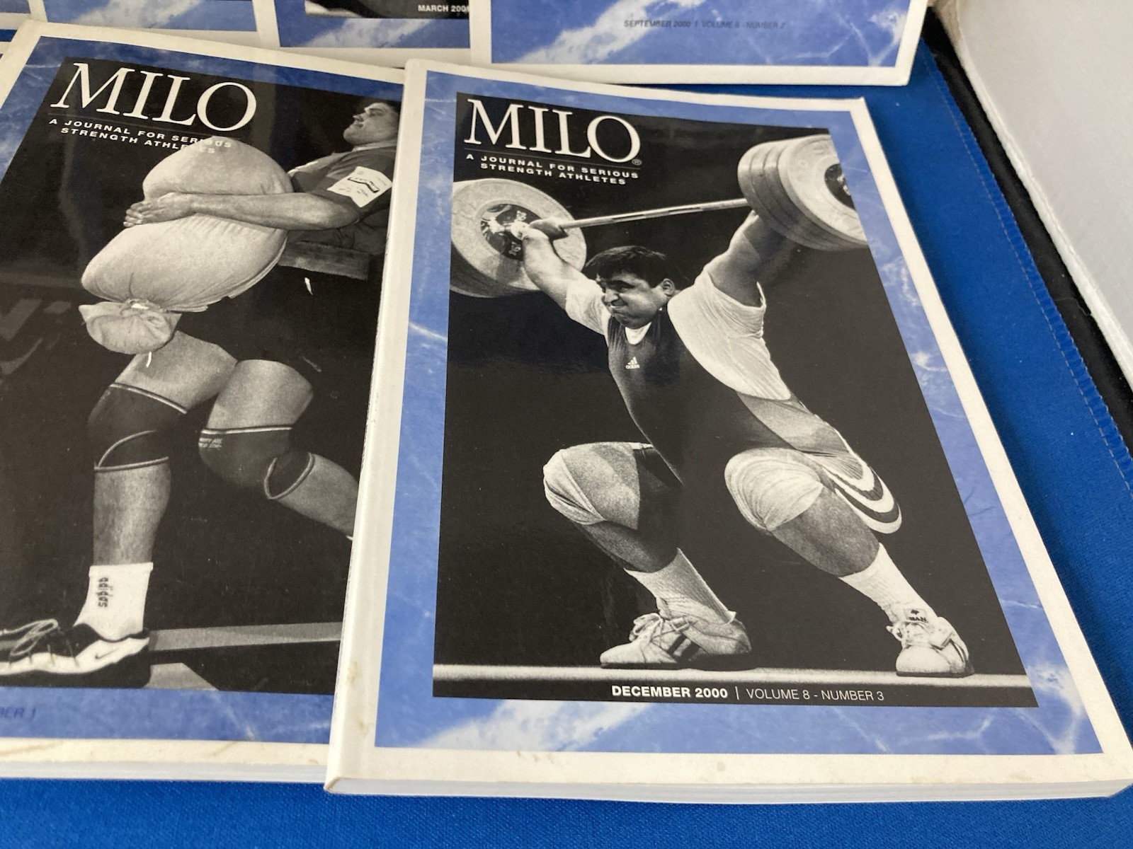 WEIGHTLIFTING-MILO JOURNALS FOR SERIOUS STRENGTH ATHLETES. LOT OF 7. 2000-2001