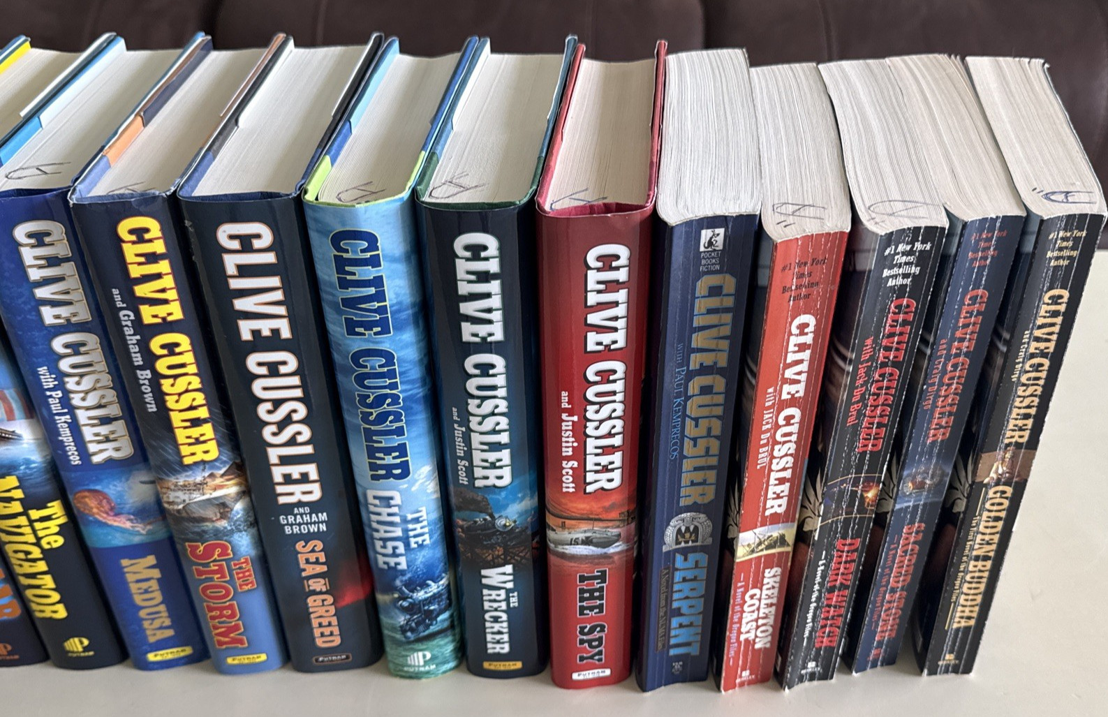 Clive Cussler Assorted Series – Lot 24 (19) Hard Cover and (5) Paperback