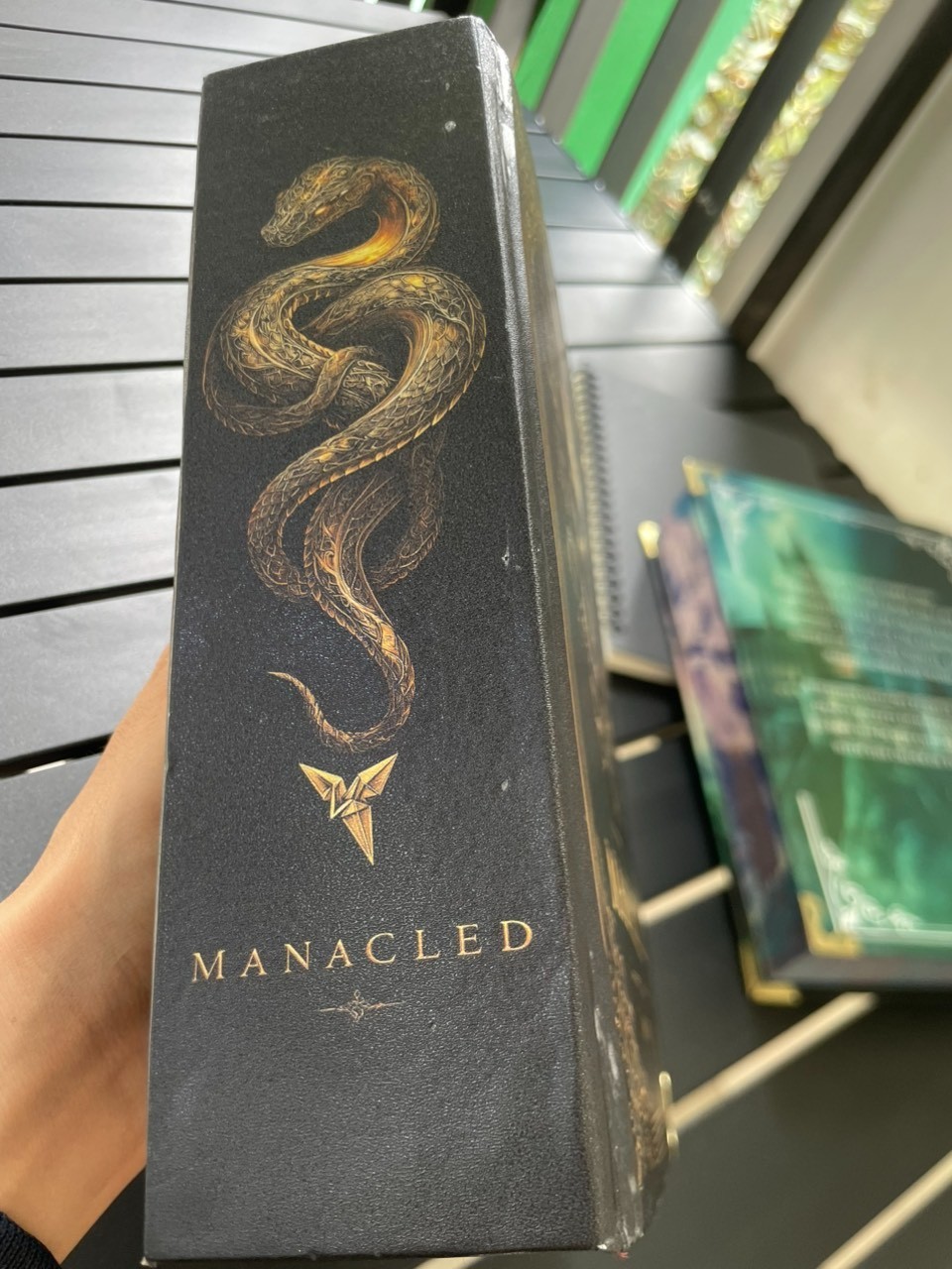 The limited edition hardcover novel Manacled (printed on three sides) collec