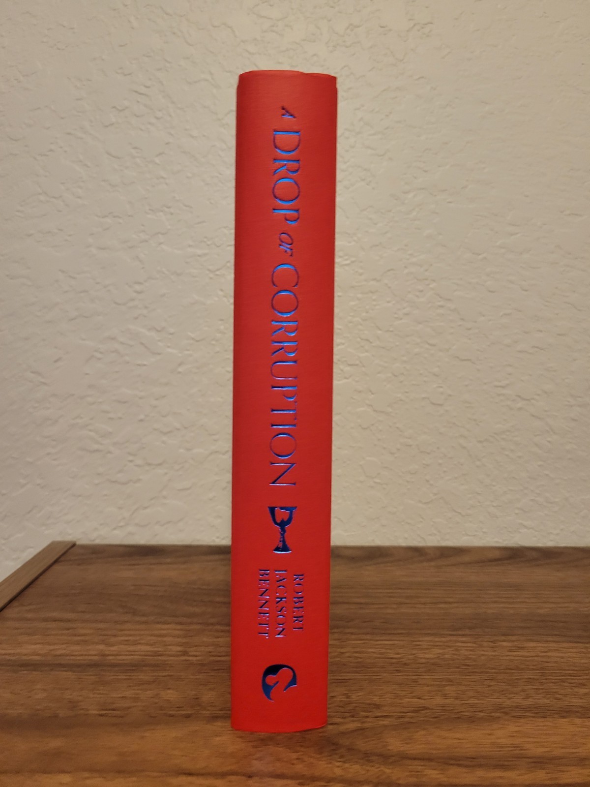 A Drop Of Corruption by Robert Jackson Bennett – Broken Binding Unsigned Edition