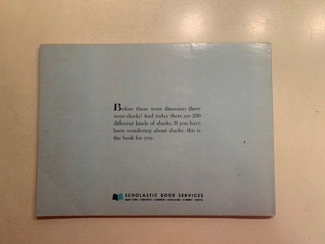 Sharks book by Ann McGovern. 47 pages. Scholastic Book services. Copyright 1976