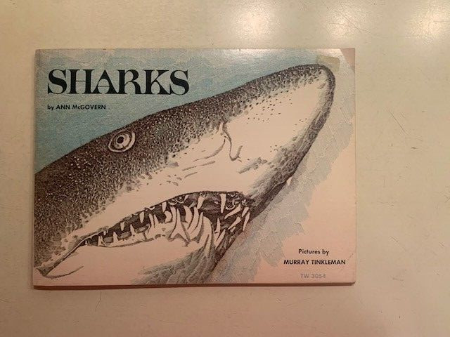 Sharks book by Ann McGovern. 47 pages. Scholastic Book services. Copyright 1976